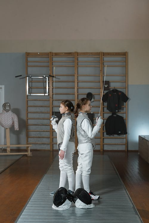 two girls ready to play a match of fencing